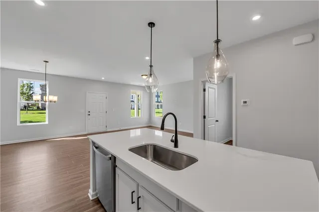 a view of a livingroom with wooden floor and a bathroom