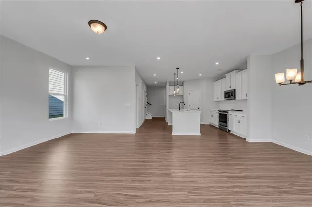 a view of kitchen and hall with wooden floor