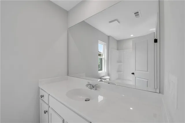 a bathroom with a double vanity sink and mirror