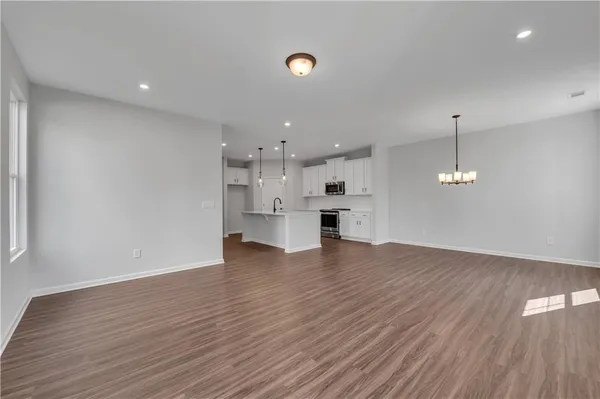 a view of kitchen and hall with wooden floor