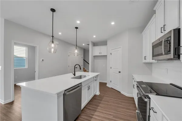 a kitchen with a sink appliances and cabinets