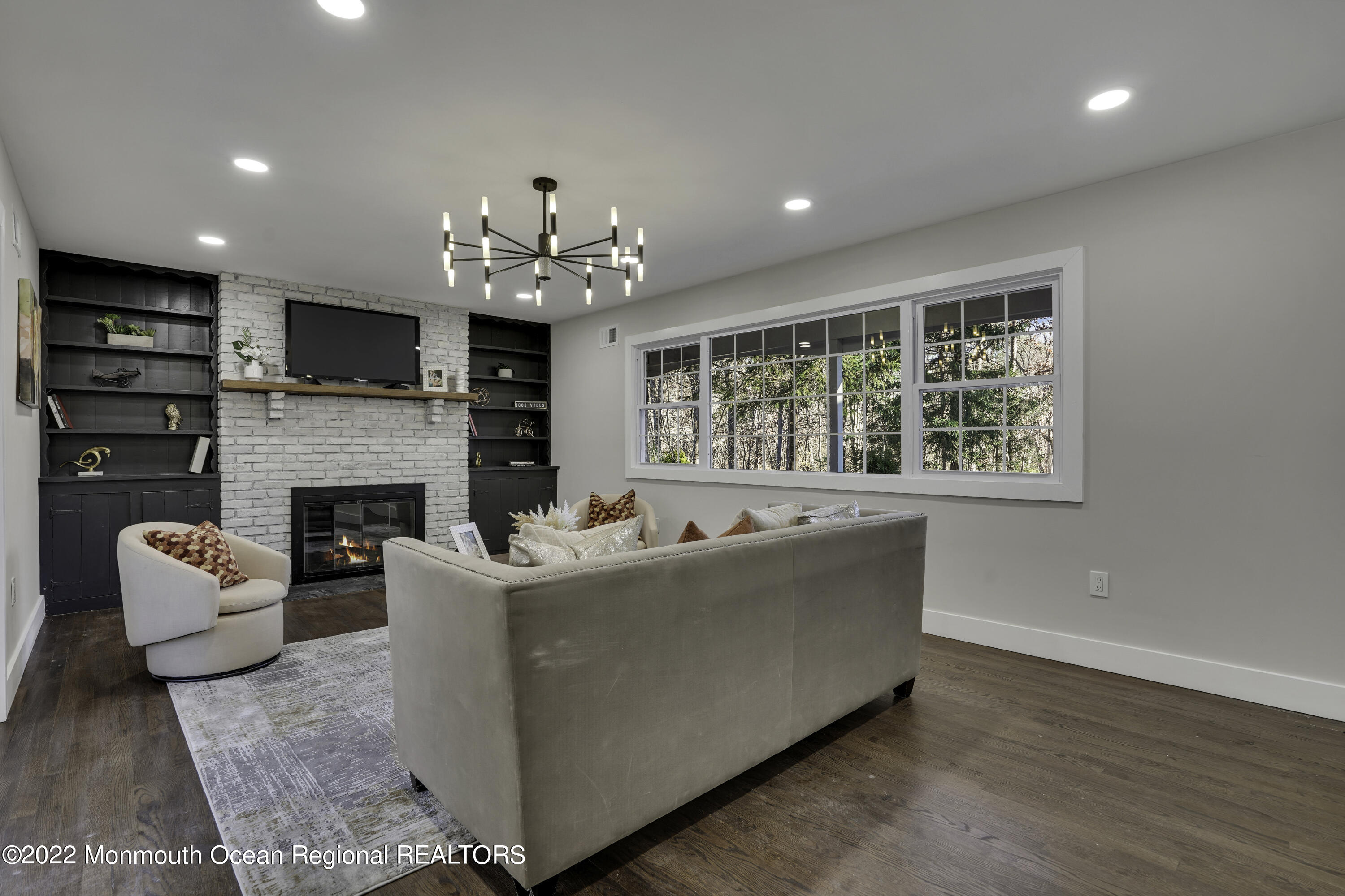614 Jackson Mills Road Jackson, NJ 08527 - Photo 11 of 64 a living room with furniture a fireplace and a flat screen tv