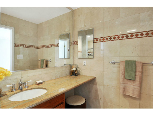 6 Spring Valley Lane Millbrae, CA 94030 - Photo 17 of 25 a bathroom with a granite countertop sink a mirror and shower