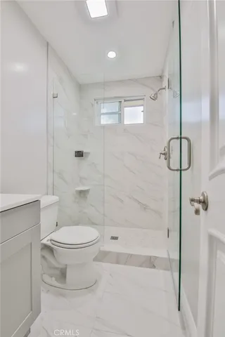 a bathroom with a toilet and a shower