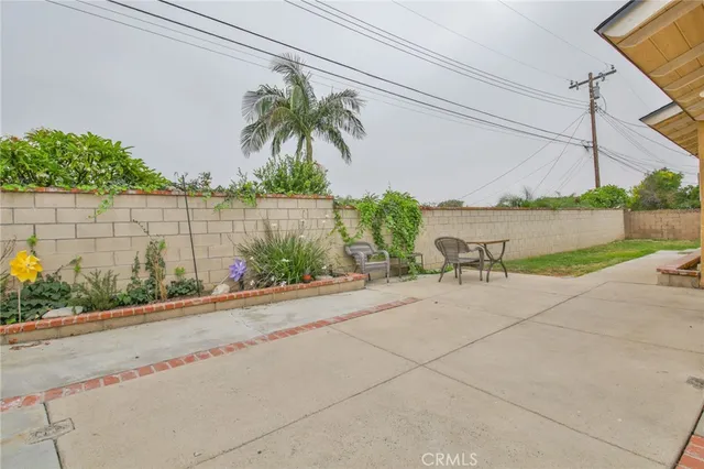 a couple of palm trees sitting in front of a house