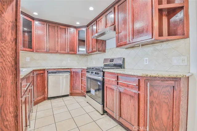 a kitchen with stainless steel appliances granite countertop a sink and cabinets