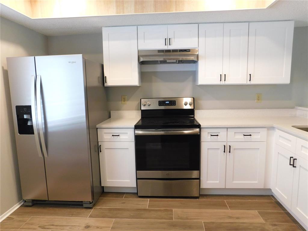 218 Caryl Way Oldsmar, FL 34677 - Photo 6 of 29 a kitchen with appliances cabinets and a counter top space