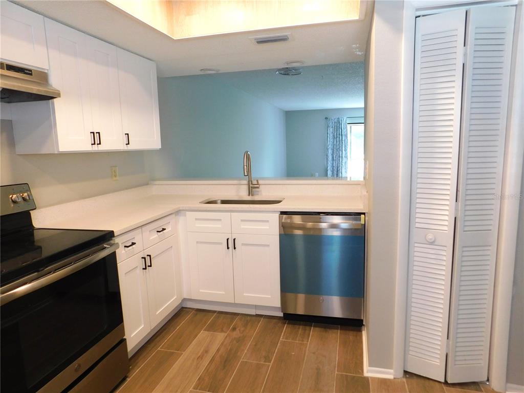 218 Caryl Way Oldsmar, FL 34677 - Photo 7 of 29 a kitchen with a sink stove and cabinets