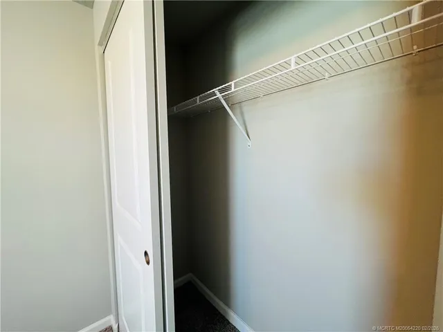 a white toilet sitting next to a wooden wall