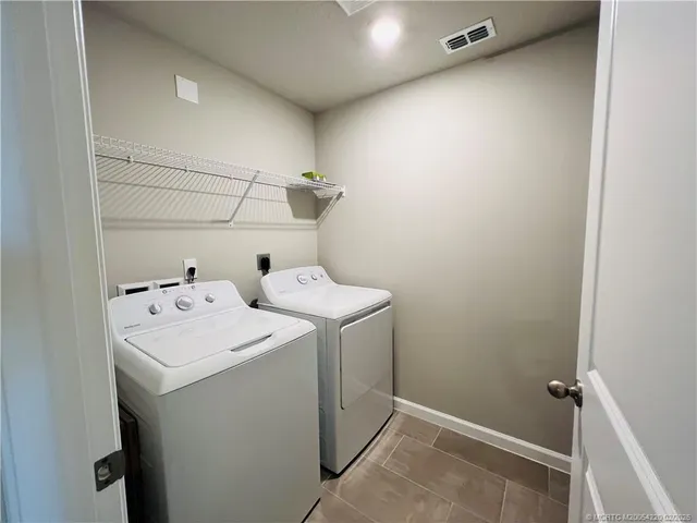 a living room with furniture a rug and a flat screen tv