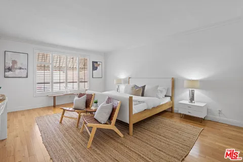 a bed room with a bed and a chair