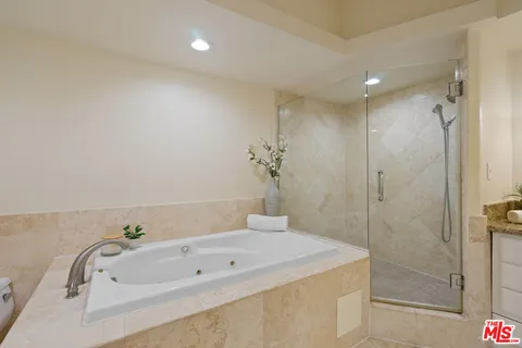 a bathroom with a tub and a shower
