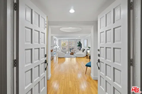 a view of a living room and entryway with furniture