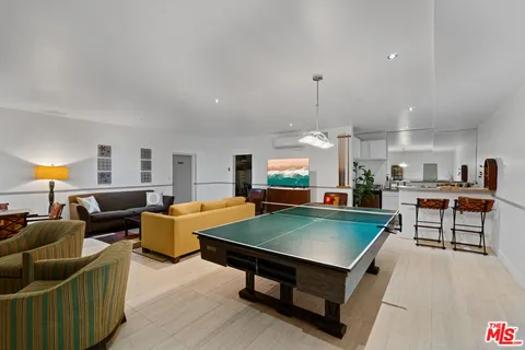 a living room with furniture a table and a flat screen tv
