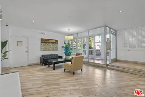 a living room with furniture and large windows