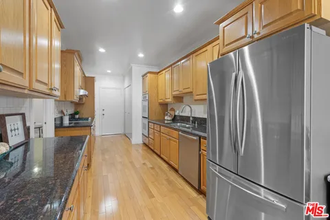 a kitchen with stainless steel appliances a refrigerator a stove and a sink