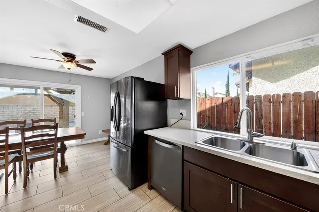 a kitchen with sink refrigerator and cabinets