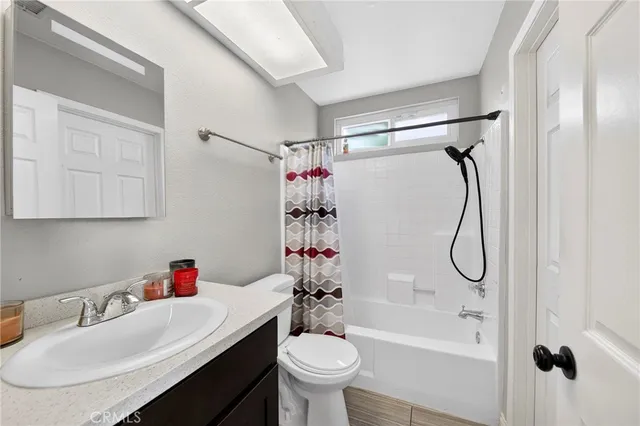 a bathroom with a sink vanity mirror and toilet