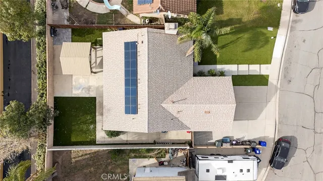 an aerial view of a house with a yard