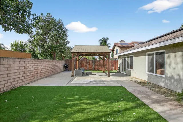 a view of a backyard with a patio and outdoor seating