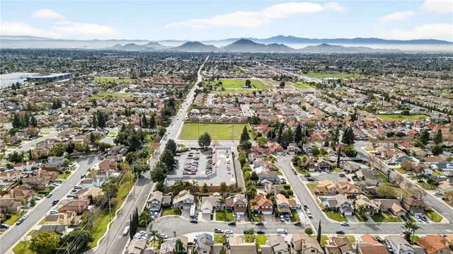 an aerial view of residential building with parking and city view