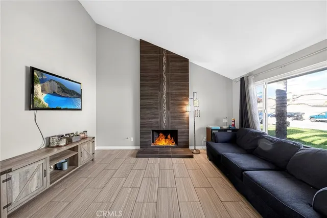 a living room with furniture fireplace and window