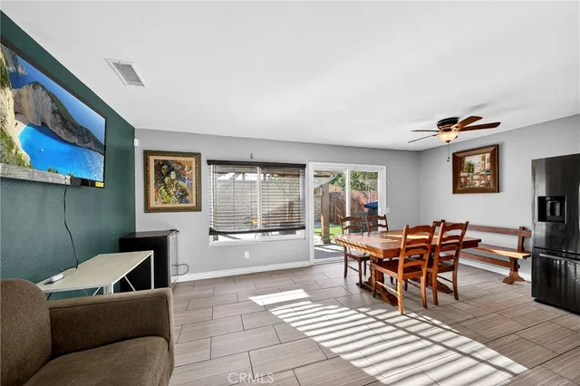 a dining room with furniture and wooden floor