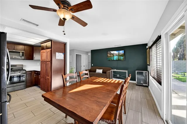 a dining room with a table chairs and a kitchen view