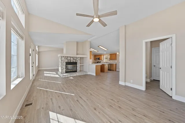 a kitchen that has a sink a stove and wooden floor