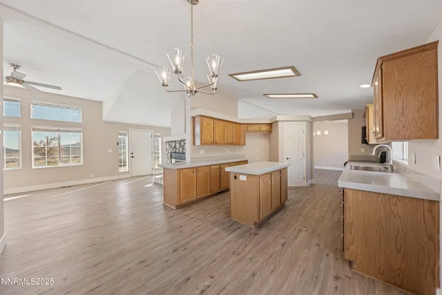 a view of a livingroom with wooden floor and a ceiling fan