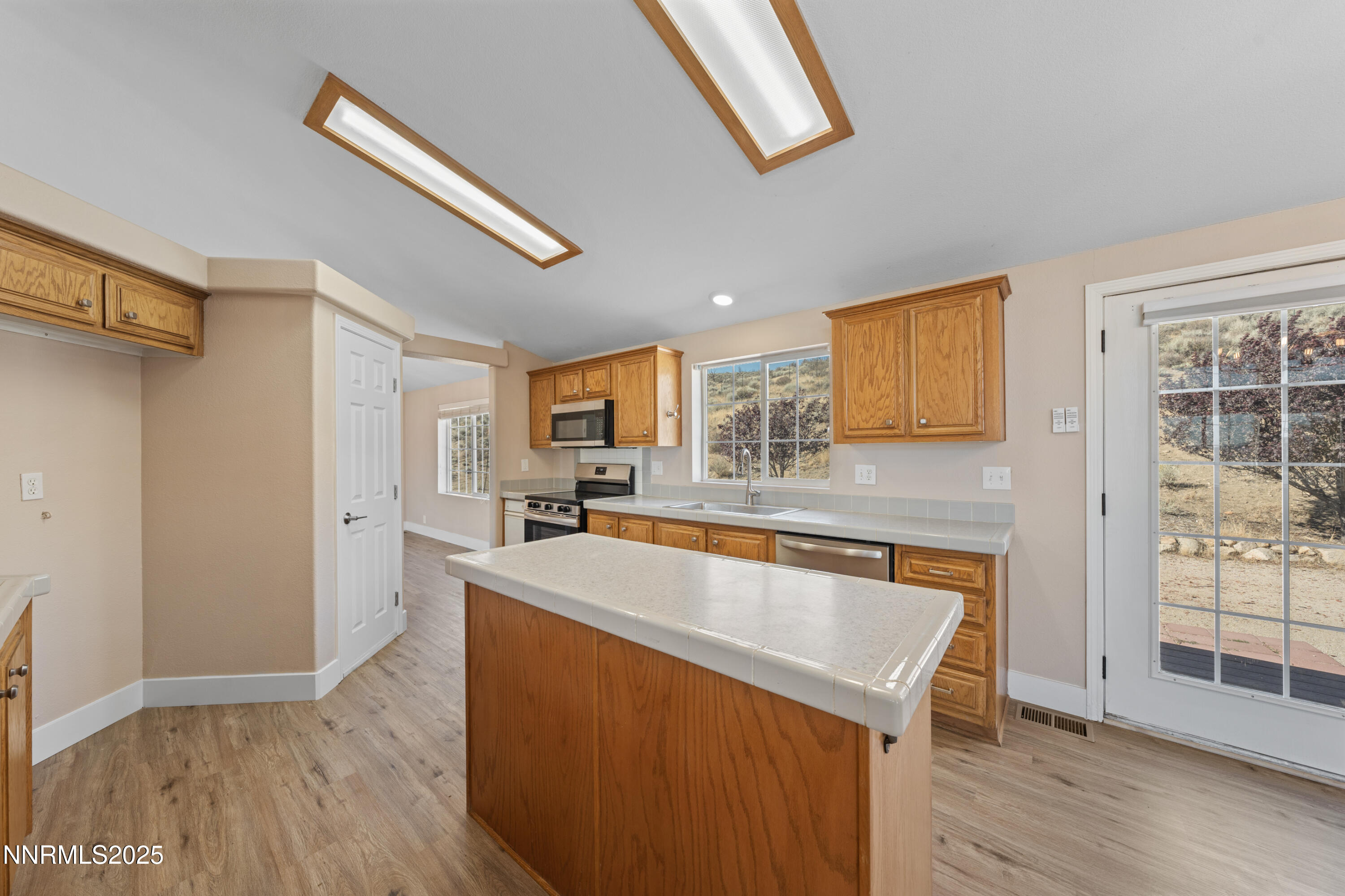 15190 North Red Rock Road Reno, NV 89508 - Photo 22 of 55 a kitchen with stainless steel appliances granite countertop a sink a stove and a refrigerator