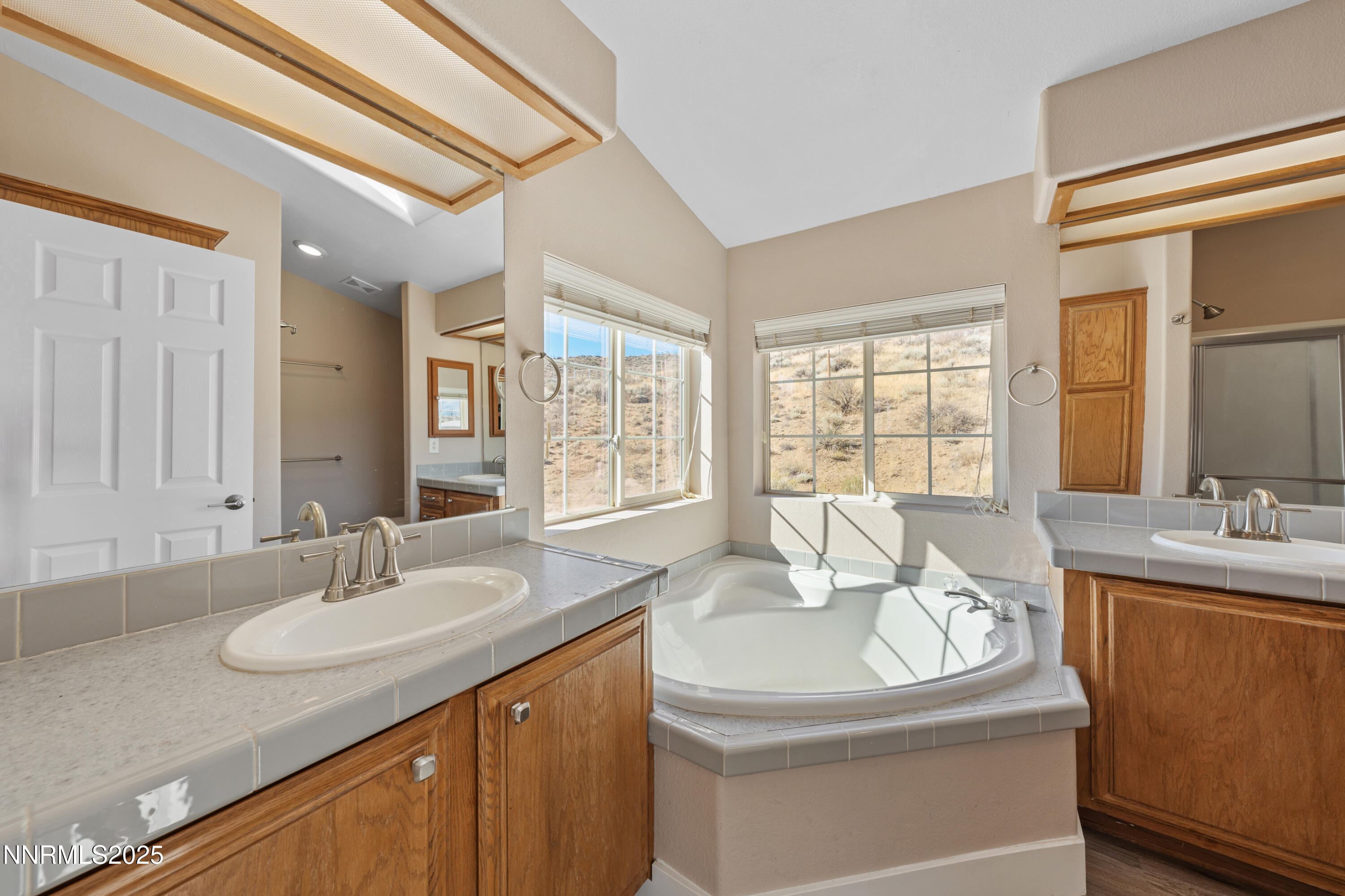 15190 North Red Rock Road Reno, NV 89508 - Photo 34 of 55 a bathroom with a granite countertop sink and a mirror