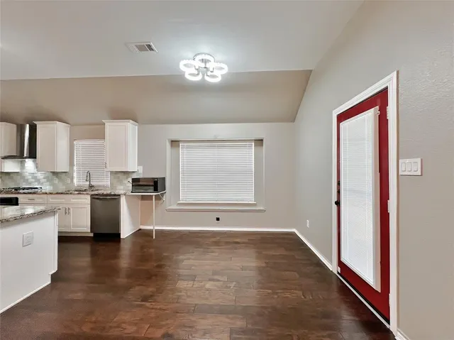 a front view of a house with a garden and deck