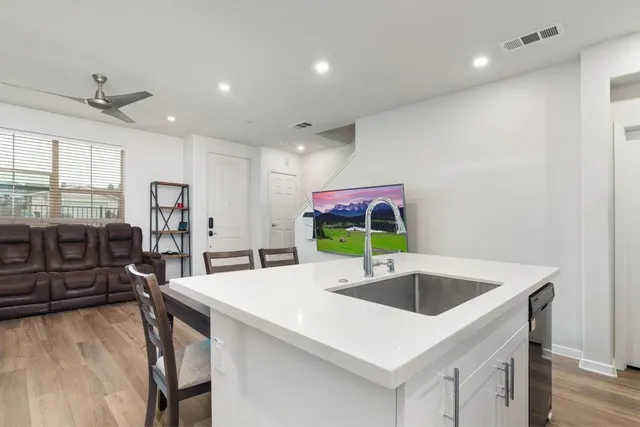 a kitchen with stainless steel appliances granite countertop a sink a oven and a refrigerator