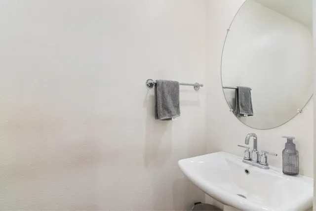 a bathroom with a sink and mirror