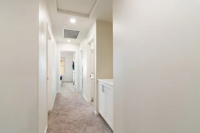 a view of a hallway with wooden shelves