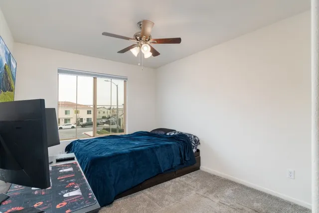a bed sitting in a bedroom next to a window