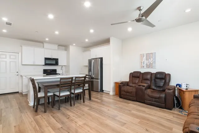 a view of a dining room with furniture and wooden floor