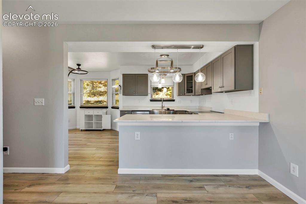 17370 Sweet Road Peyton, CO 80831 - Photo 21 of 38 The updated kitchen; completely new in 2024 features new cabinets, countertops, sink and lighting. Great storage space and updated appliances. Clean, modern farmhouse feel that will be your favorite room in the house.