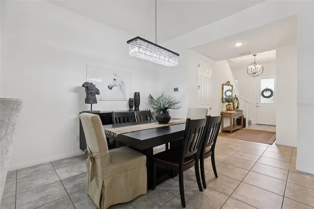 a kitchen with a stove a sink a dining table and chairs