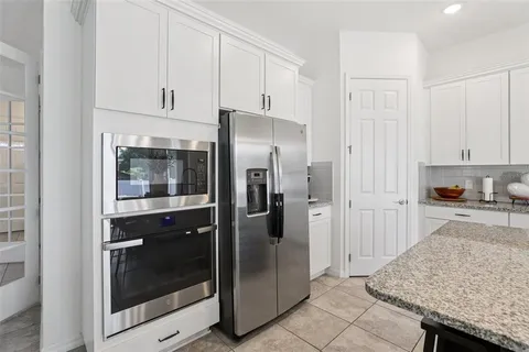 a spacious bedroom with a bed and a cabinets