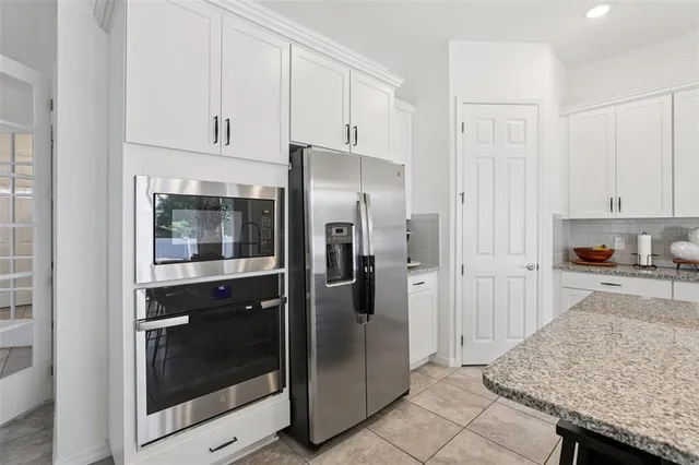 a spacious bedroom with a bed and a cabinets