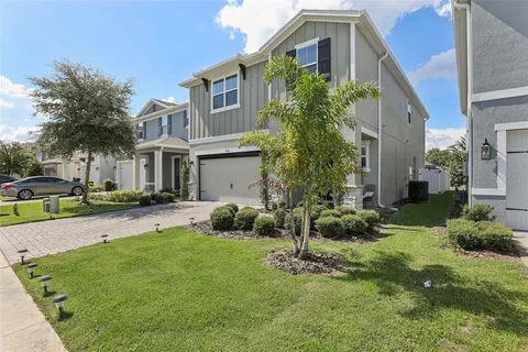 a front view of a house with a yard and porch