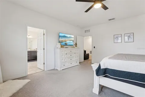 a bathroom with a double vanity sink toilet and a mirror