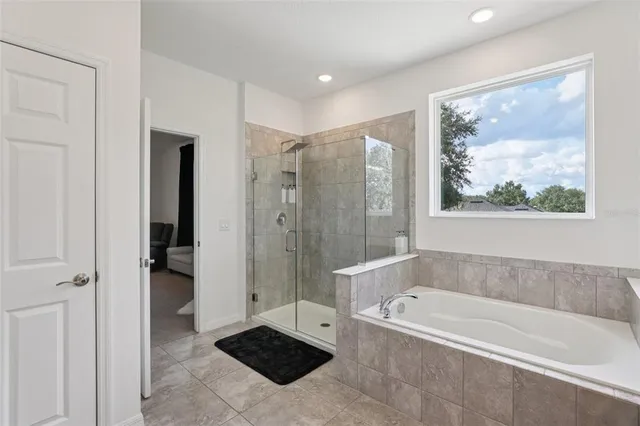 a bed sitting in a bedroom and dresser with wooden floor
