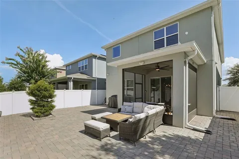 an aerial view of a city with lots of residential buildings ocean and mountain view in back