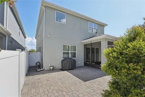 an aerial view of a house with swimming pool and mountains