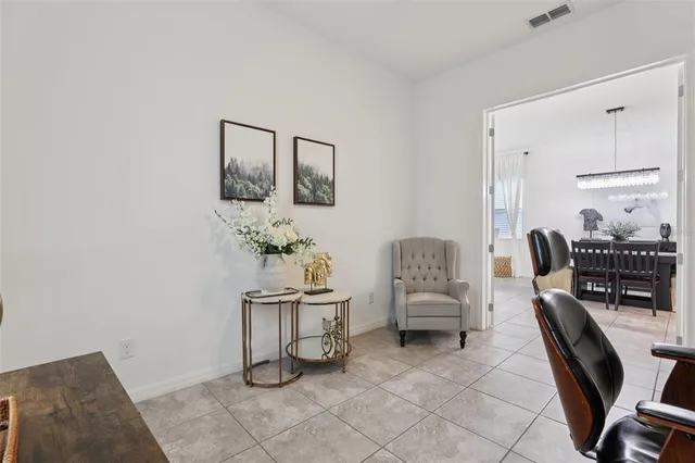 a view of a dining room with furniture and chandelier