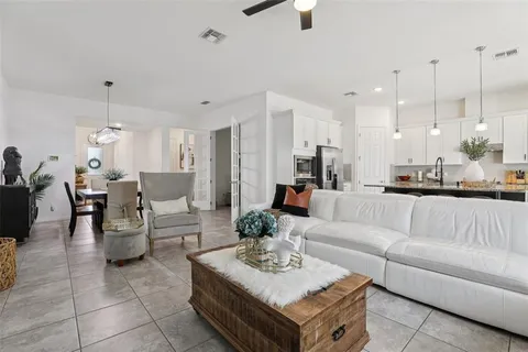 a dining room with furniture and a chandelier