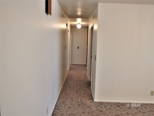 601 Weiman Avenue Ridgecrest, CA 93555 - Photo 16 of 35 a view of a hallway with wooden floor